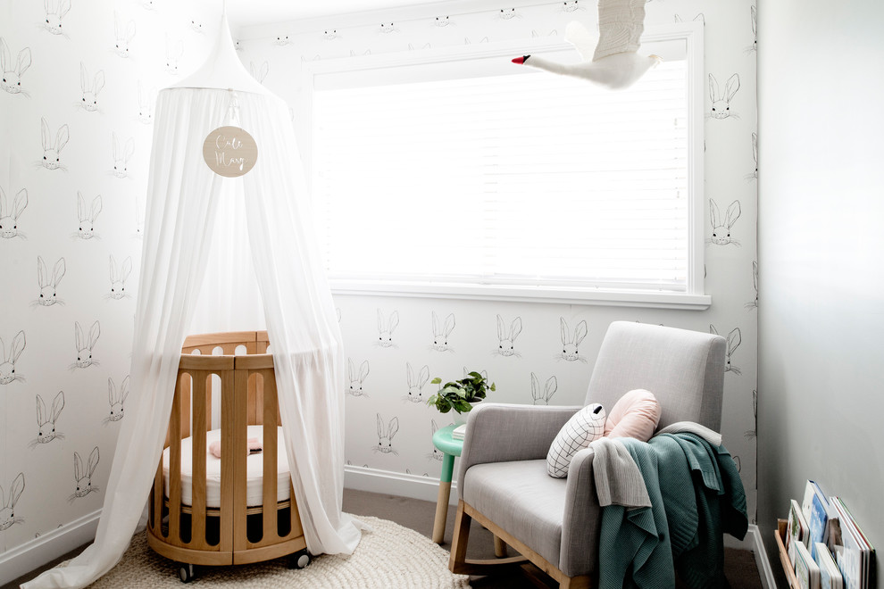 This is an example of a small modern nursery for girls in Hobart with white walls, carpet and grey floor.