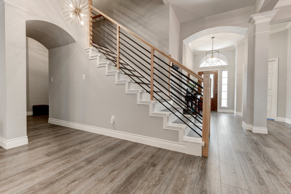 Design ideas for a mid-sized transitional wood u-shaped staircase in Austin with concrete risers and wood railing.