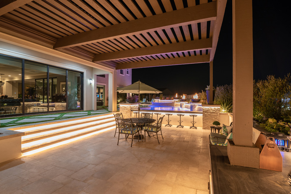 Inspiration for a contemporary backyard patio in Orange County with a fire feature, tile and a pergola.