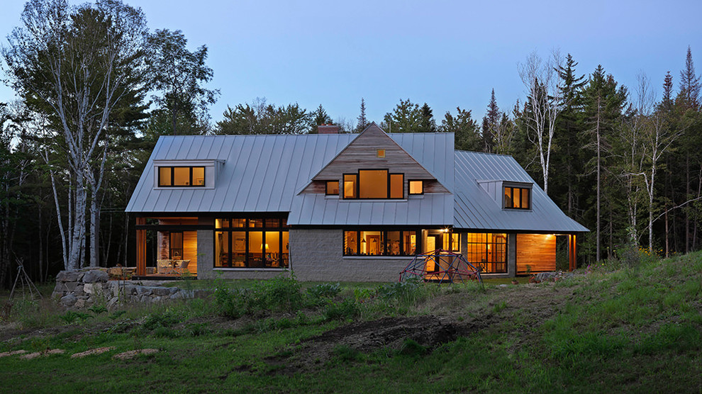 This is an example of a mid-sized country two-storey brown house exterior in Orange County with wood siding, a gable roof and a metal roof.