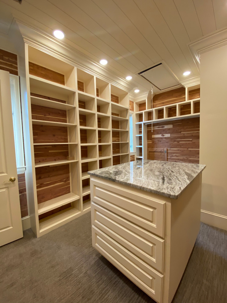 Inspiration for a large contemporary gender-neutral walk-in wardrobe in Other with white cabinets, carpet, grey floor, timber and raised-panel cabinets.