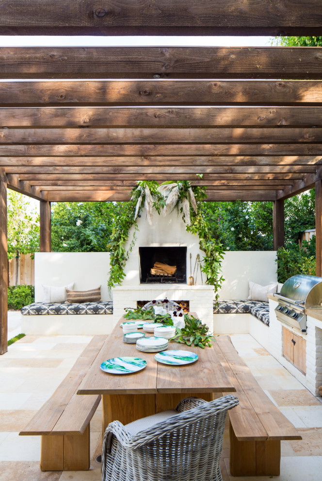Design ideas for a transitional backyard patio in Orange County with with fireplace and a pergola.