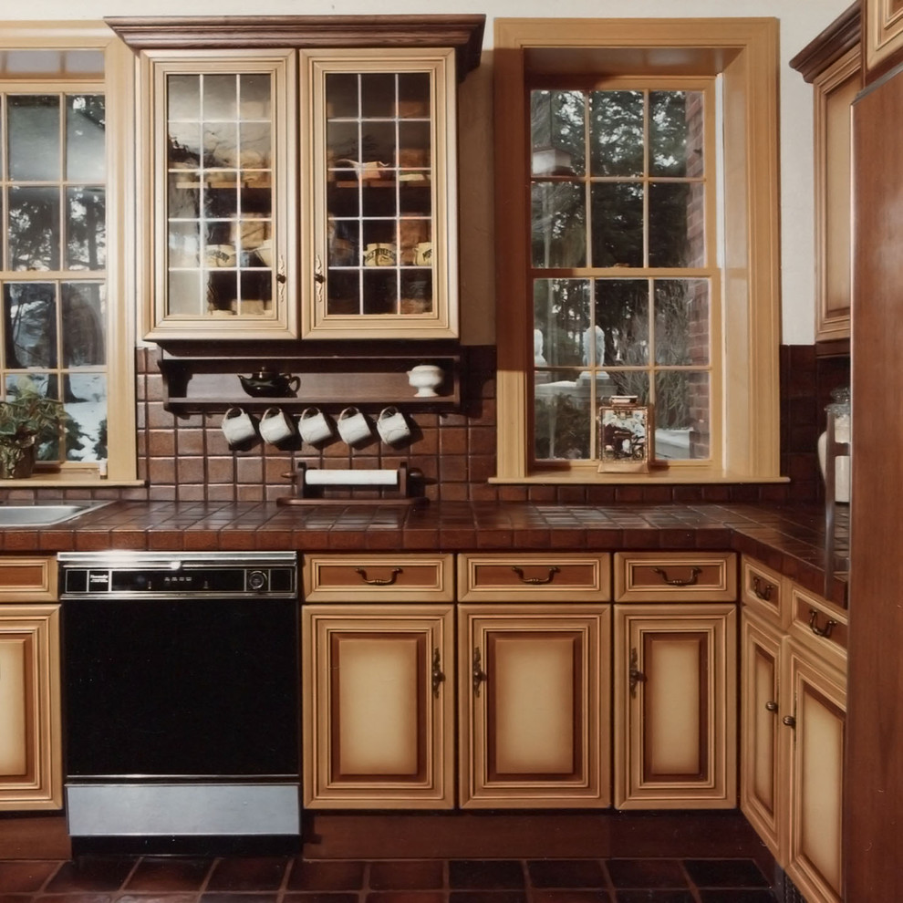Photo of a large traditional u-shaped eat-in kitchen in Boston with a double-bowl sink, recessed-panel cabinets, beige cabinets, tile benchtops, terra-cotta floors, with island and brown floor.