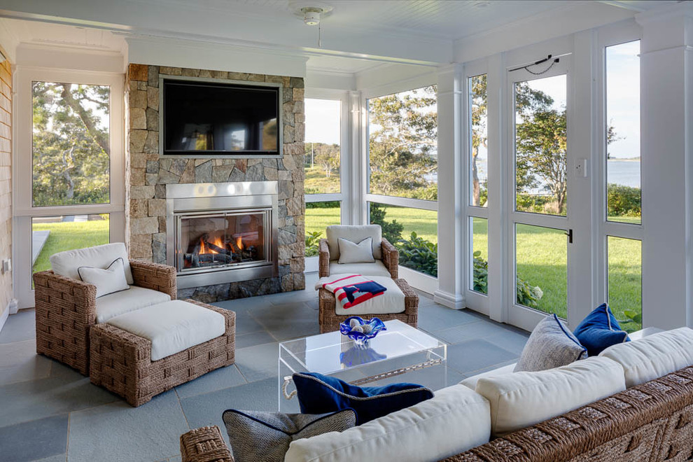 Mid-sized beach style sunroom in Boston with concrete floors, a standard fireplace, a stone fireplace surround and a standard ceiling.