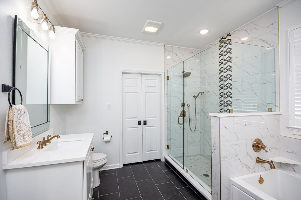 Photo of an expansive transitional master bathroom in New Orleans with raised-panel cabinets, white cabinets, an alcove tub, an alcove shower, white tile, porcelain tile, white walls, porcelain floors, an undermount sink, black floor, a hinged shower door, grey benchtops, a single vanity and a built-in vanity.