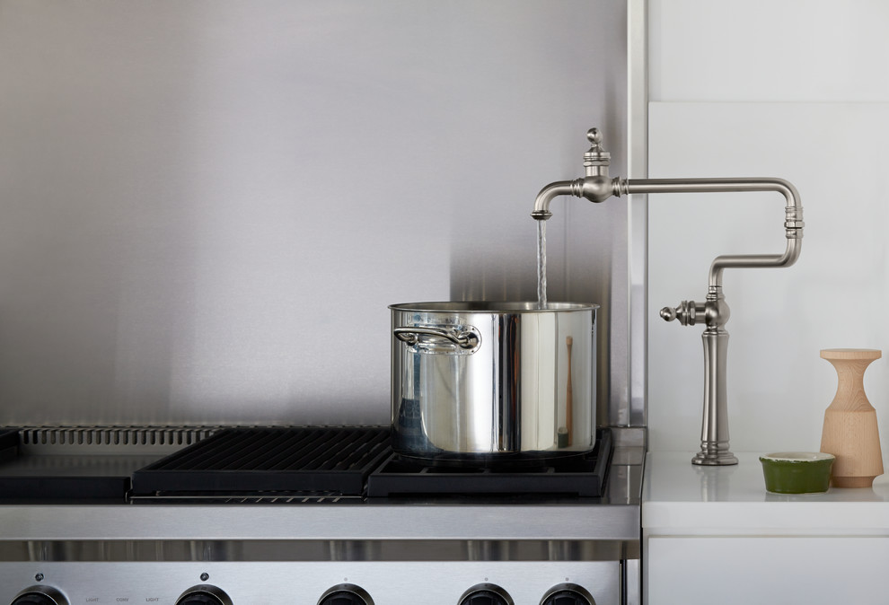 Example of an urban kitchen design in Miami with granite countertops and brick backsplash