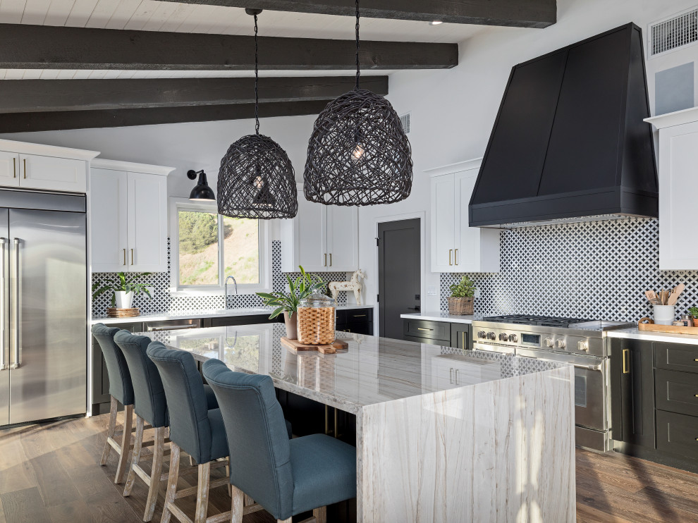 Kitchen - transitional l-shaped dark wood floor, brown floor, exposed beam and vaulted ceiling kitchen idea with an undermount sink, shaker cabinets, black cabinets, multicolored backsplash, mosaic tile backsplash, stainless steel appliances, an island and white countertops