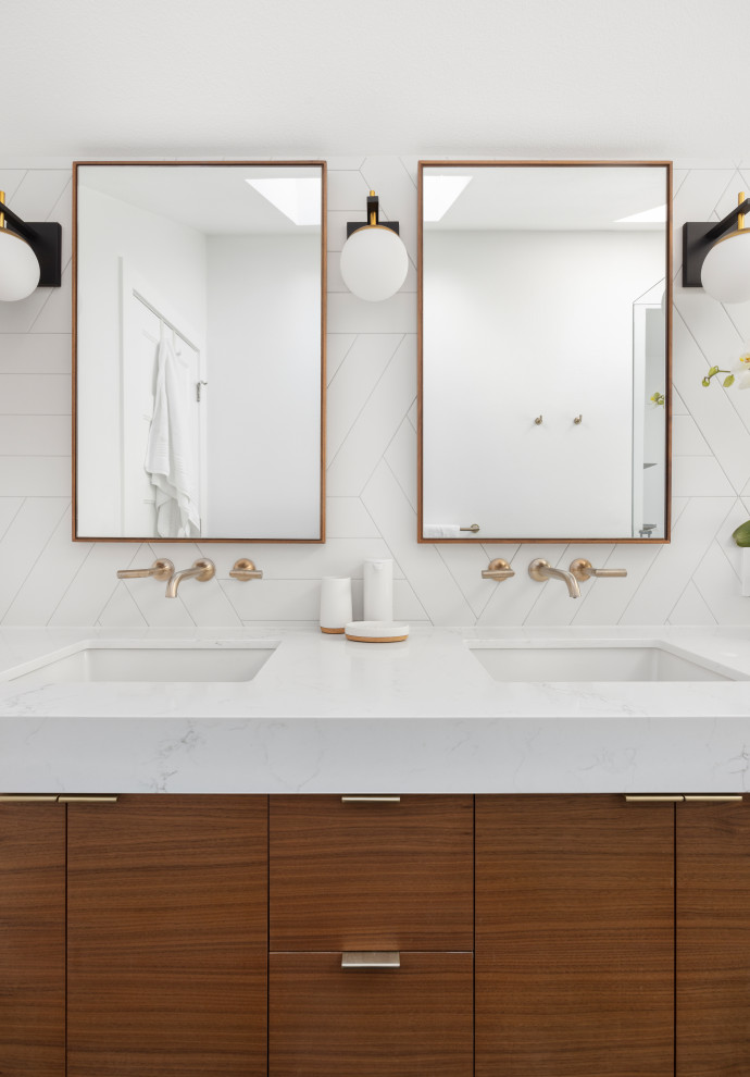 This is an example of a mid-sized modern master bathroom in Portland with flat-panel cabinets, medium wood cabinets, a curbless shower, a one-piece toilet, white tile, porcelain tile, white walls, ceramic floors, an undermount sink, engineered quartz benchtops, blue floor, a hinged shower door, white benchtops, a double vanity, a built-in vanity, vaulted and a shower seat.