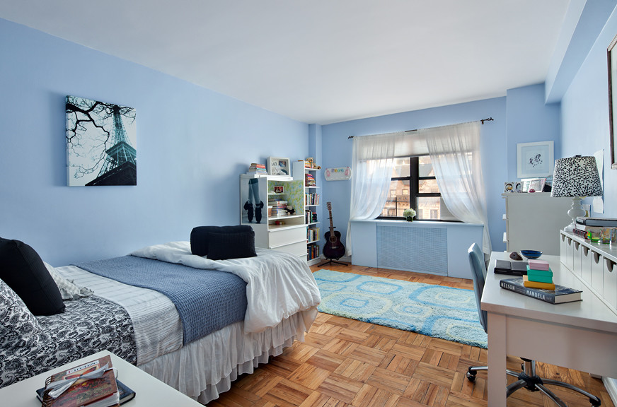 Kids' bedroom - large and bedroom transitional girl medium tone wood floor kids' bedroom idea in New York with blue walls