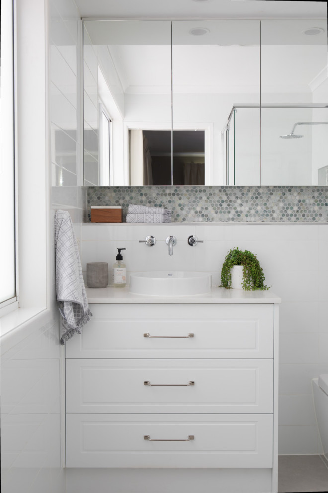 Design ideas for a small bathroom in Brisbane with white cabinets, white tile, white walls, a drop-in sink, engineered quartz benchtops, grey floor and white benchtops.