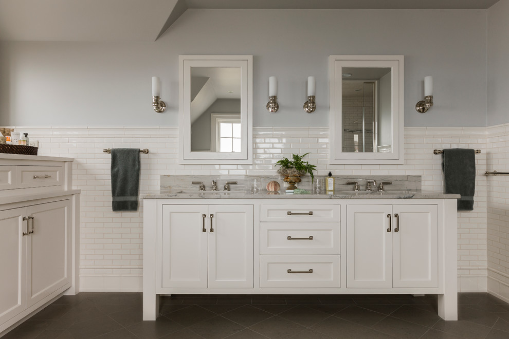 Photo of a beach style master bathroom in Boston with an undermount sink, white cabinets, quartzite benchtops, white tile, porcelain floors and shaker cabinets.