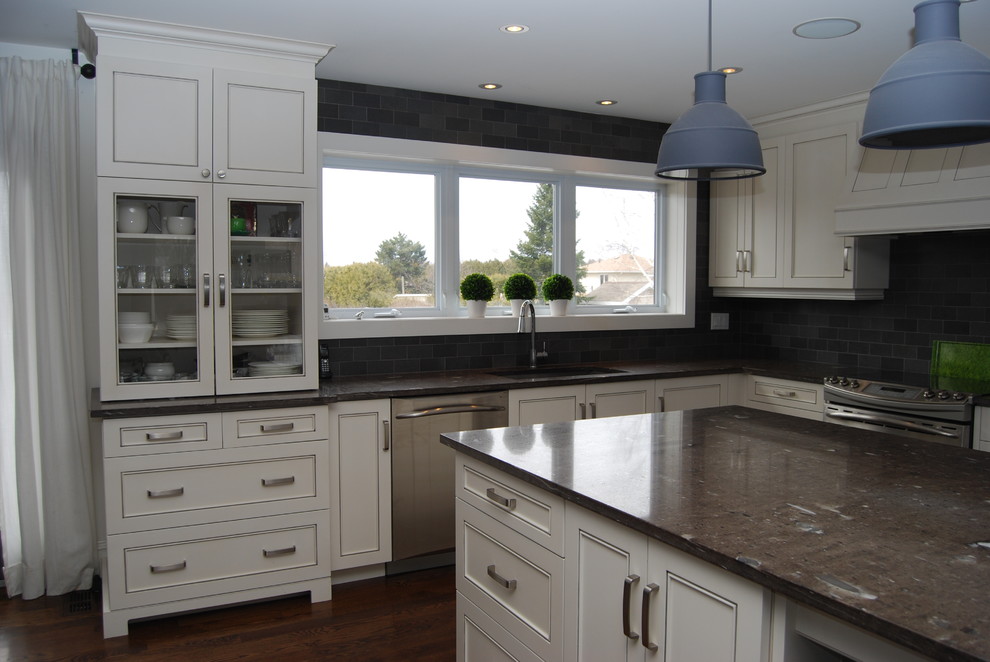 Design ideas for a traditional l-shaped eat-in kitchen in Ottawa with an undermount sink, distressed cabinets, granite benchtops, grey splashback, stone tile splashback and stainless steel appliances.