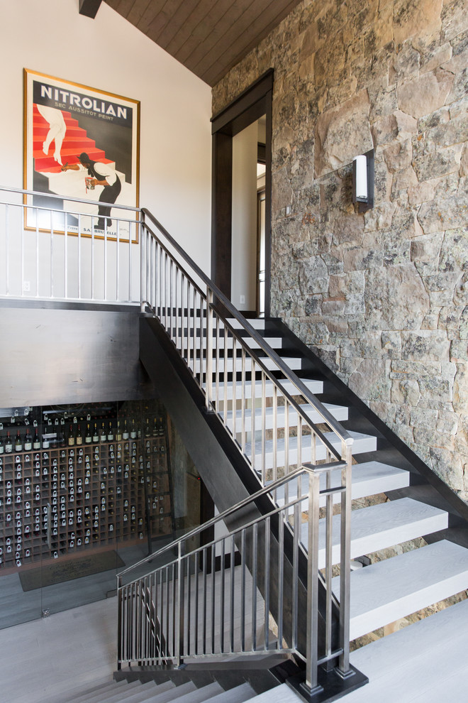 This is an example of a transitional concrete staircase in Salt Lake City with open risers and metal railing.