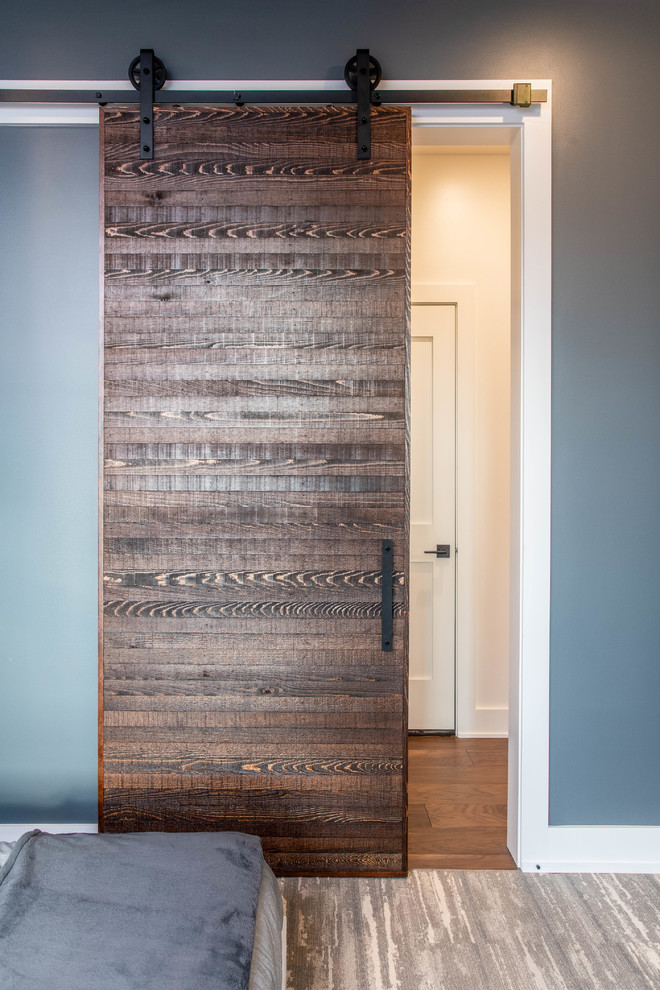 Organic Modern Mountain Home - A rustic kids' room designed for ages 4 to 10, featuring cozy double deck beds, soft gray carpet flooring, and a warm, playful ambiance. This functional and eco-friendly space is part of the sustainable organic modern mountain home