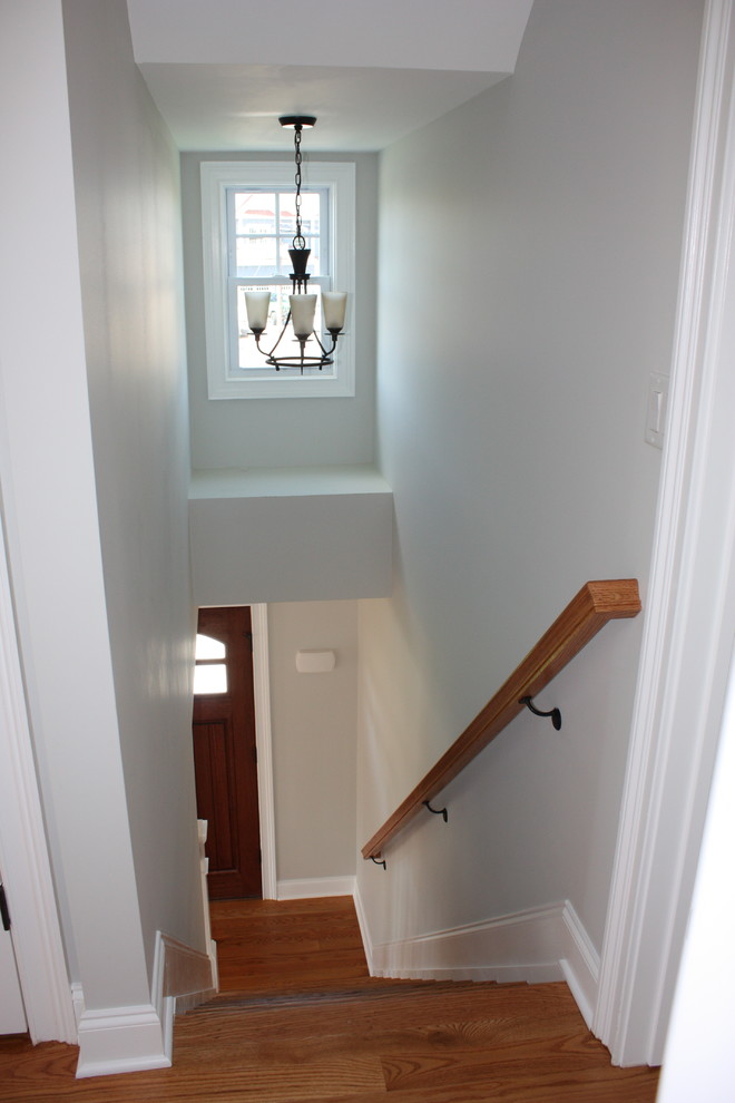 Small arts and crafts wood straight staircase in New York with painted wood risers.