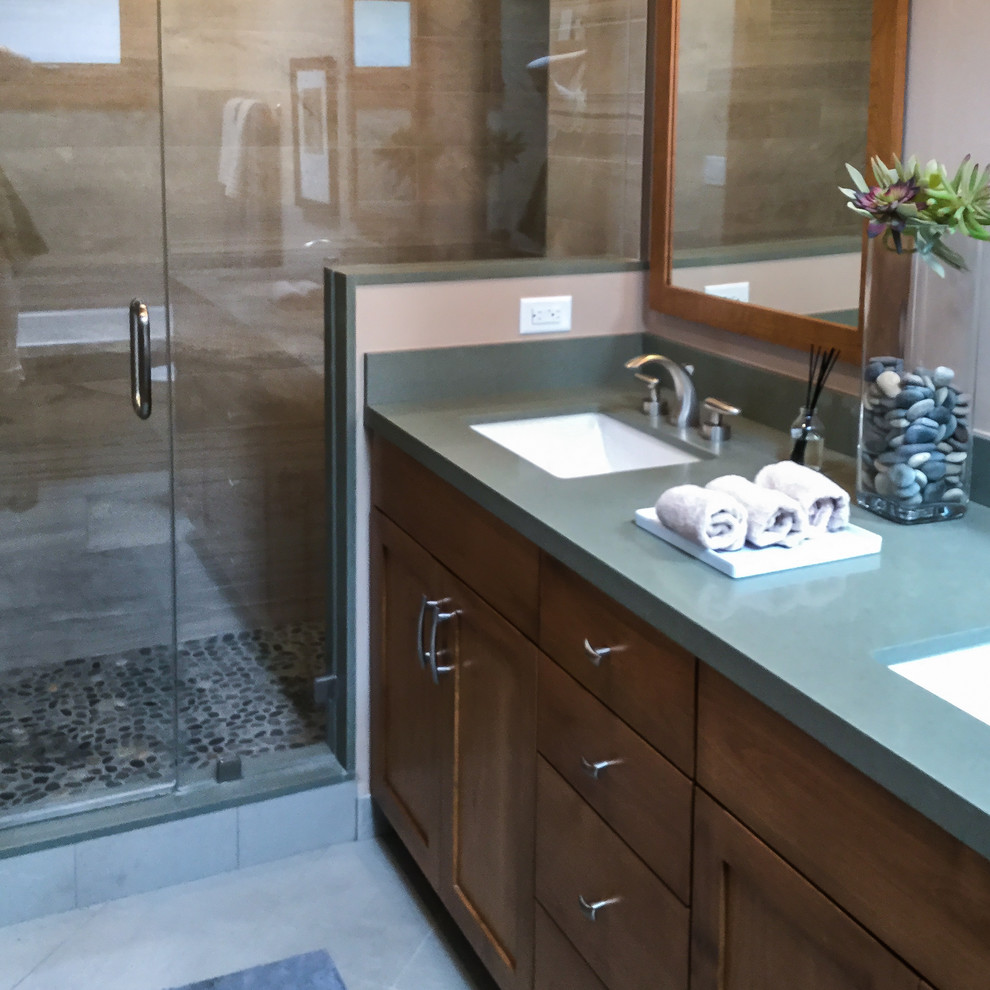 Mid-sized transitional master gray tile and porcelain tile cement tile floor and gray floor drop-in bathtub photo with recessed-panel cabinets, dark wood cabinets, beige walls, an undermount sink, quartz countertops and a hinged shower door