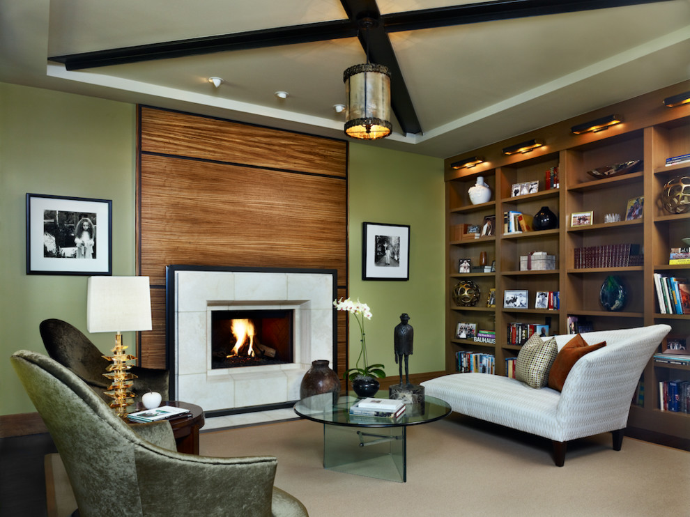Design ideas for a mid-sized contemporary living room in Denver with a library, green walls, dark hardwood floors, a standard fireplace, a tile fireplace surround and no tv.