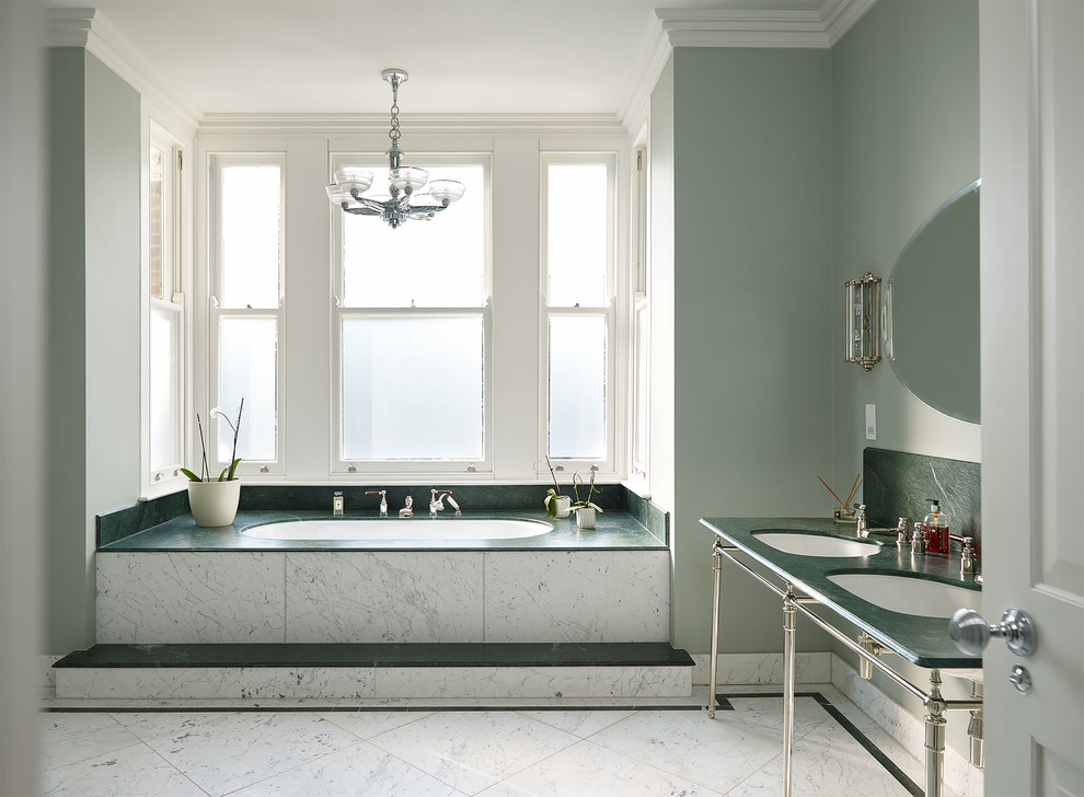 Design ideas for a large traditional kids bathroom in London with a drop-in tub and marble benchtops.
