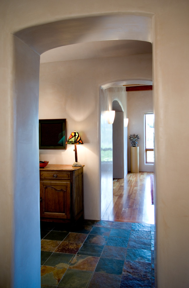 Photo of a large hallway in Albuquerque with white walls and slate floors.