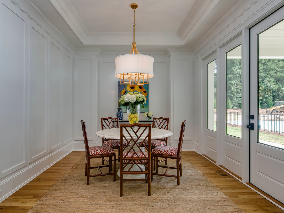 Photo of a transitional dining room in Raleigh with grey walls, medium hardwood floors and no fireplace.
