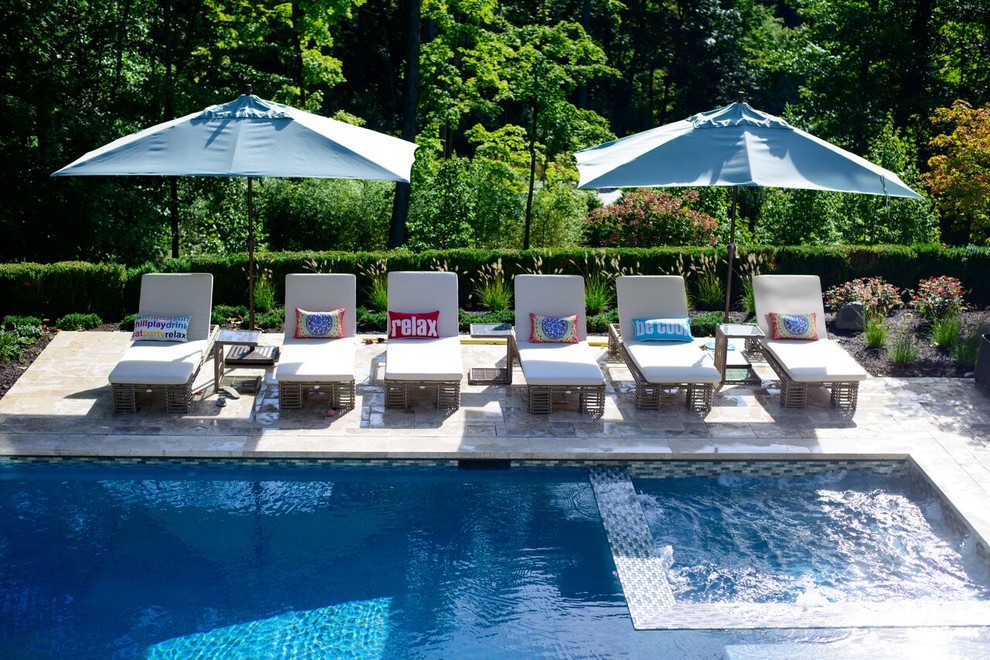 Large backyard stone and custom-shaped lap hot tub photo in New York