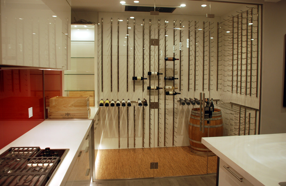 Photo of a mid-sized contemporary wine cellar in Calgary with light hardwood floors and storage racks.