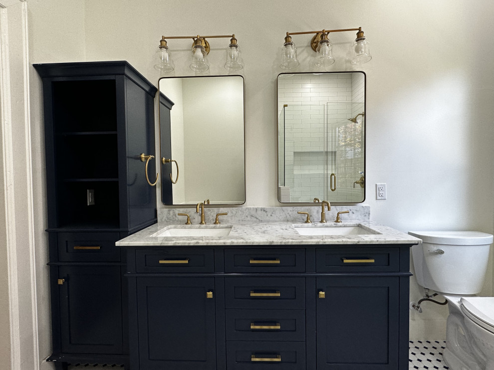 This is an example of a mid-sized traditional bathroom in Dallas with shaker cabinets, blue cabinets, a drop-in tub, a two-piece toilet, white tile, subway tile, a drop-in sink, stainless steel benchtops, a hinged shower door, a shower seat, a double vanity and a freestanding vanity.