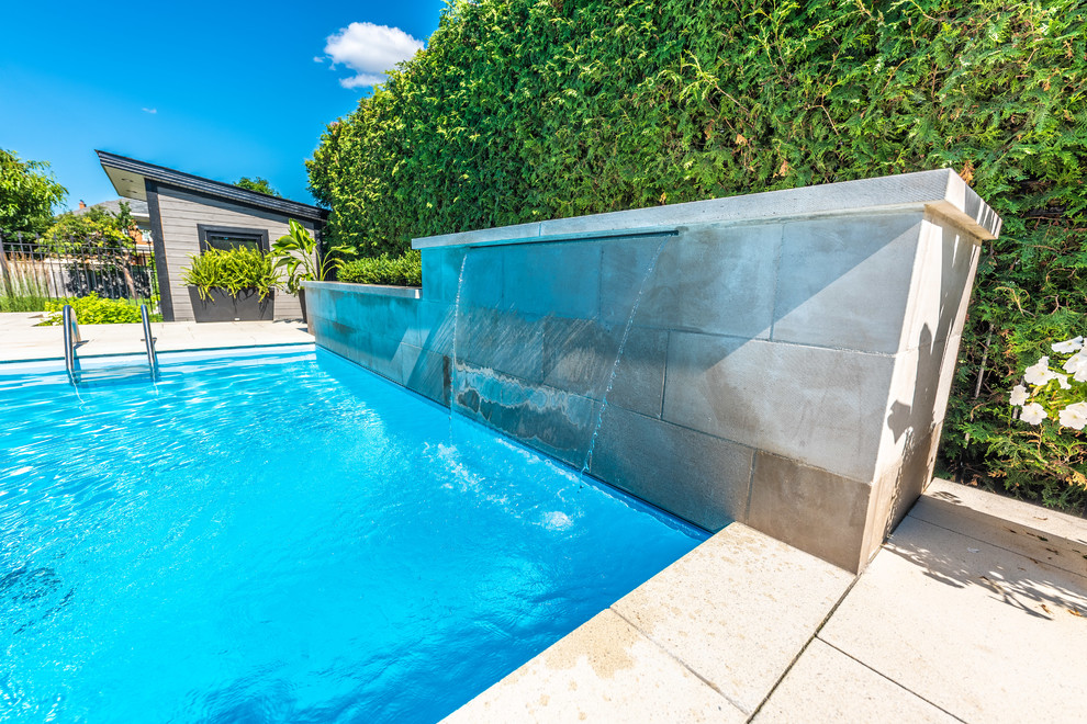 Inspiration for a mid-sized transitional backyard brick and rectangular lap pool fountain remodel in Toronto