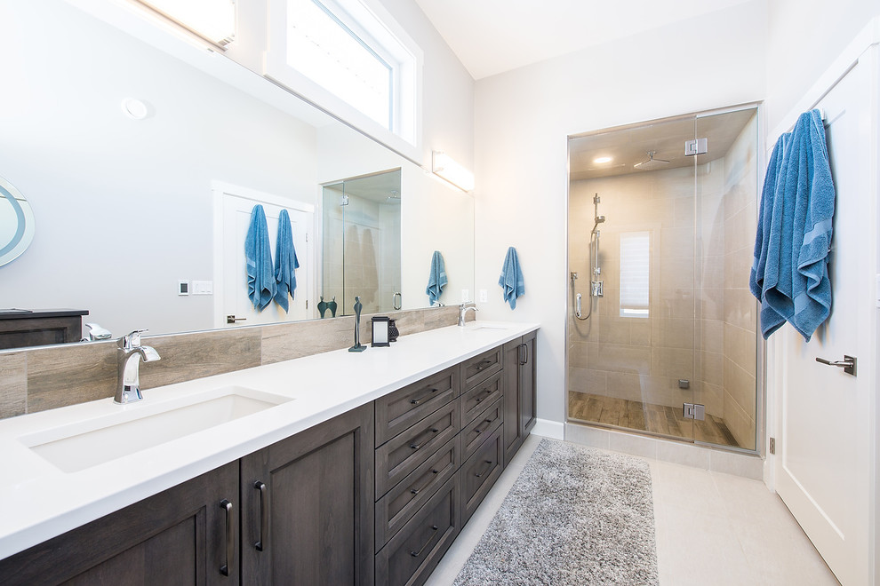 Inspiration for a large traditional master bathroom in Edmonton with shaker cabinets, brown cabinets, a one-piece toilet, brown tile, ceramic tile, an undermount sink, engineered quartz benchtops and white benchtops.