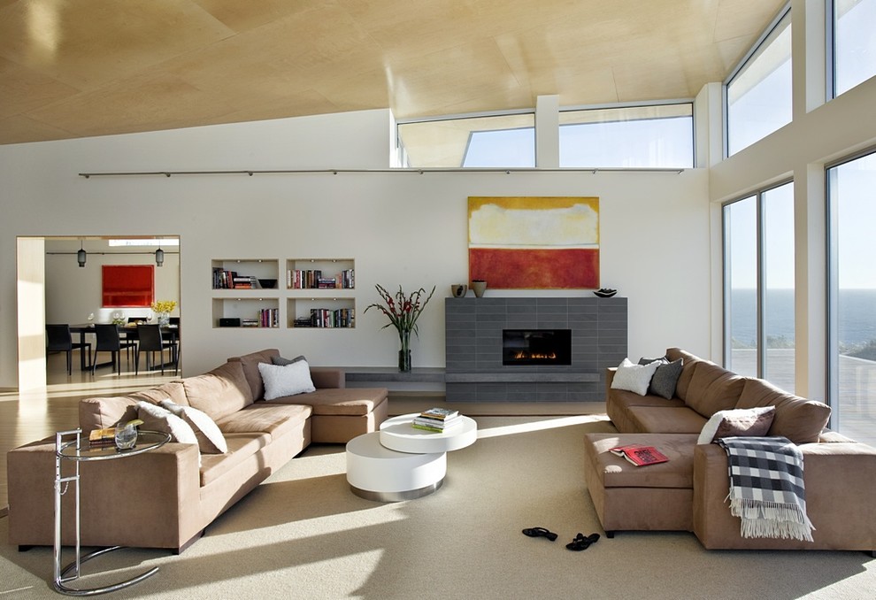 This is an example of an expansive modern living room in Boston with white walls.