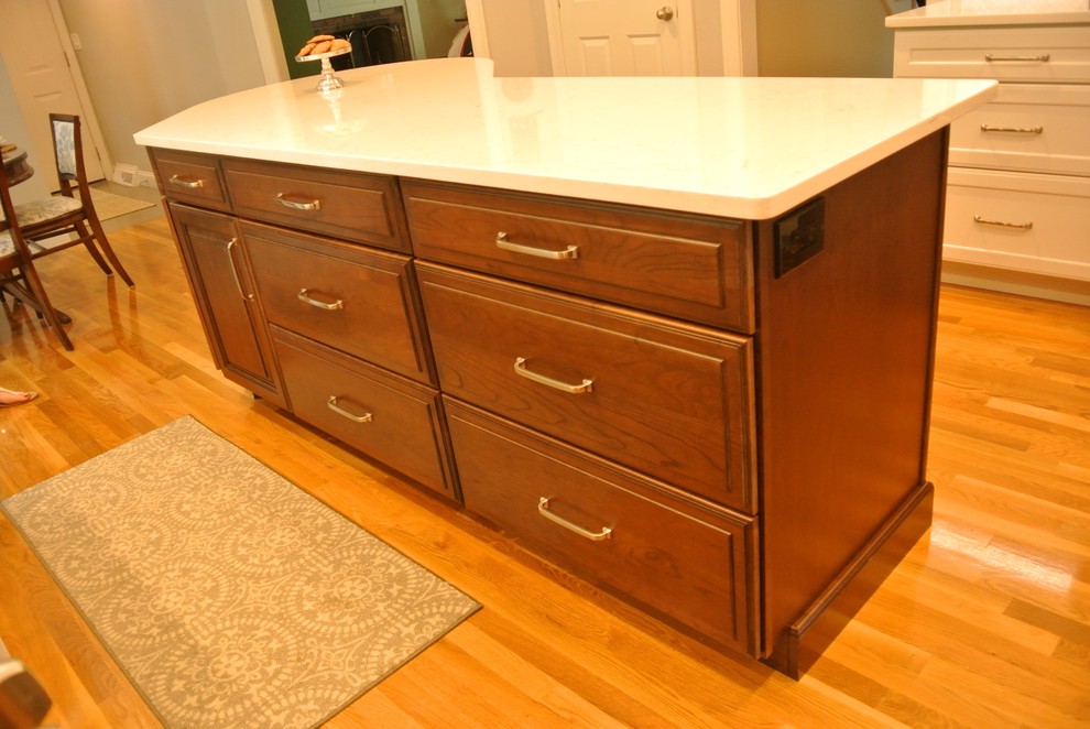 Inspiration for a transitional medium tone wood floor eat-in kitchen remodel in Boston with an undermount sink, shaker cabinets, quartz countertops, beige backsplash, mosaic tile backsplash, stainless steel appliances, an island and white countertops