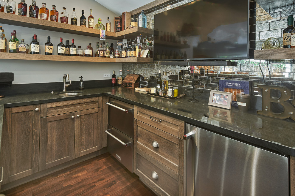 Inspiration for a large country u-shaped seated home bar in San Francisco with an undermount sink, shaker cabinets, distressed cabinets, quartz benchtops, multi-coloured splashback, glass tile splashback, dark hardwood floors, brown floor and brown benchtop.