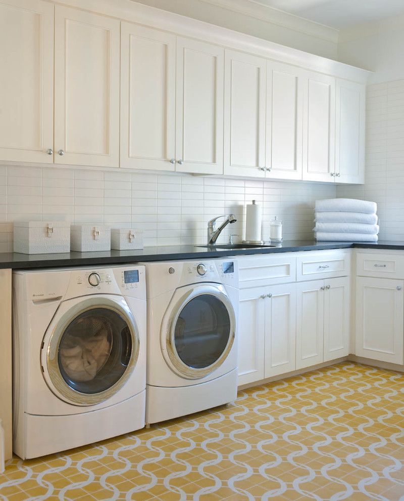 Design ideas for a transitional laundry room in Dallas with yellow floor.