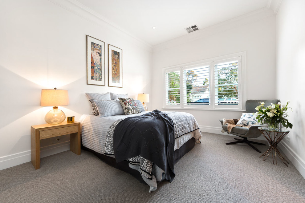Photo of a mid-sized contemporary bedroom in Melbourne with white walls and carpet.
