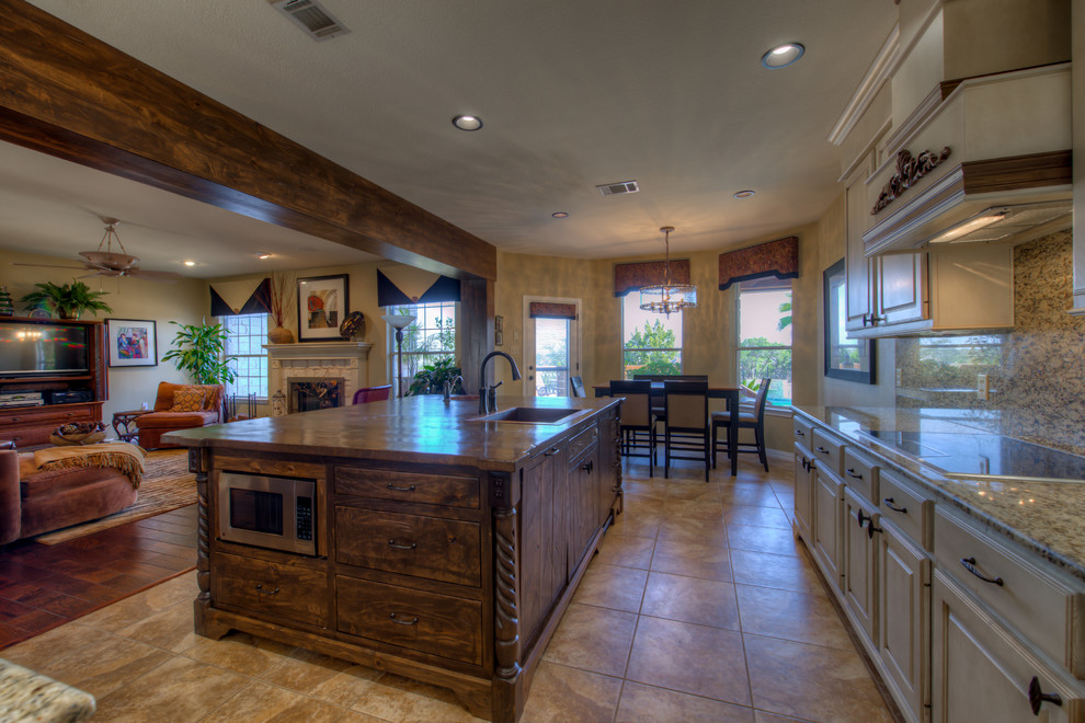 Eat-in kitchen - mid-sized rustic l-shaped eat-in kitchen idea in Austin with a single-bowl sink, wood countertops, stainless steel appliances and an island