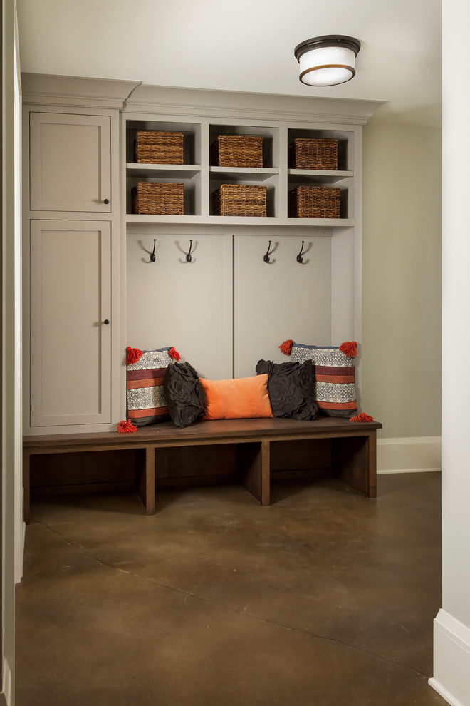 This is an example of a mid-sized transitional mudroom in Minneapolis with white walls, concrete floors and grey floor.