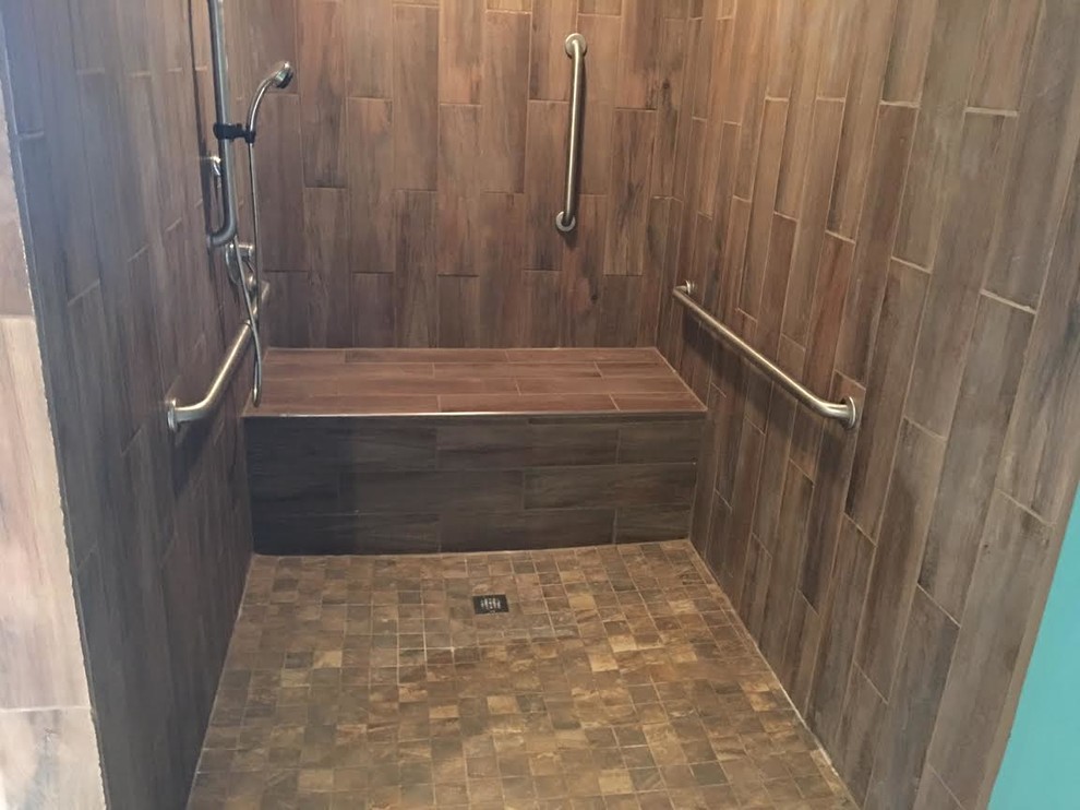 Example of a transitional brown tile and porcelain tile alcove shower design