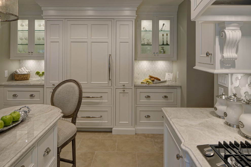 This is an example of a mid-sized traditional u-shaped kitchen in Chicago with a farmhouse sink, beaded inset cabinets, white cabinets, quartzite benchtops, grey splashback, porcelain splashback, panelled appliances and with island.