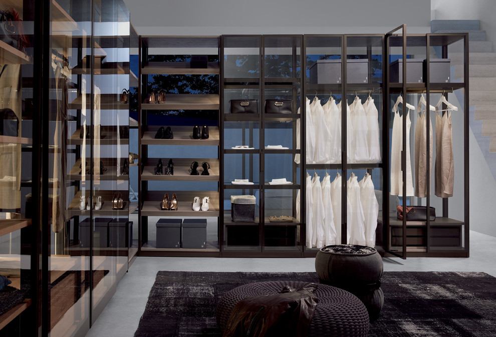 Large transitional women's walk-in wardrobe in Madrid with open cabinets and black cabinets.