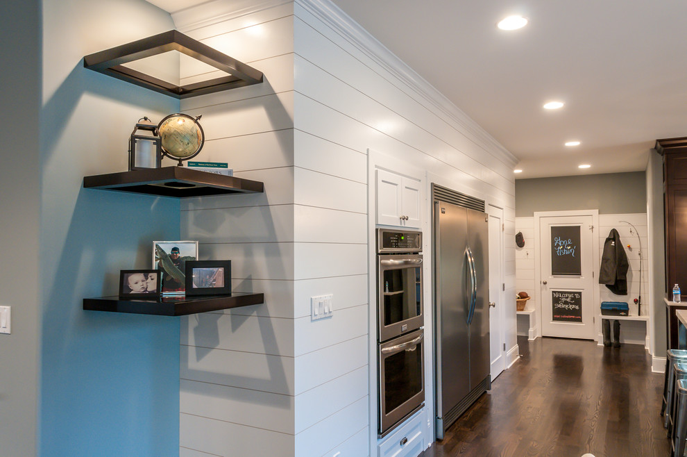 Example of a mid-sized transitional l-shaped dark wood floor eat-in kitchen design in Chicago with an undermount sink, recessed-panel cabinets, dark wood cabinets, quartzite countertops, multicolored backsplash, mirror backsplash, stainless steel appliances and an island