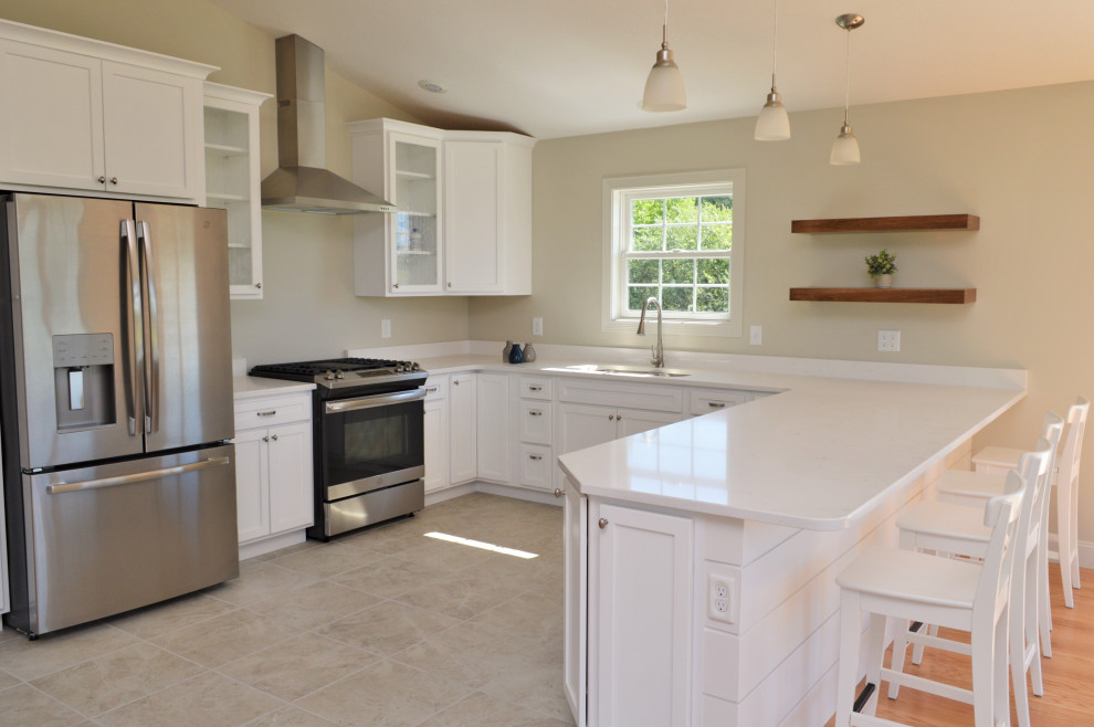 Mid-sized country u-shaped open plan kitchen in Other with an undermount sink, shaker cabinets, white cabinets, quartzite benchtops, stainless steel appliances, ceramic floors, a peninsula, beige floor, white benchtop and vaulted.