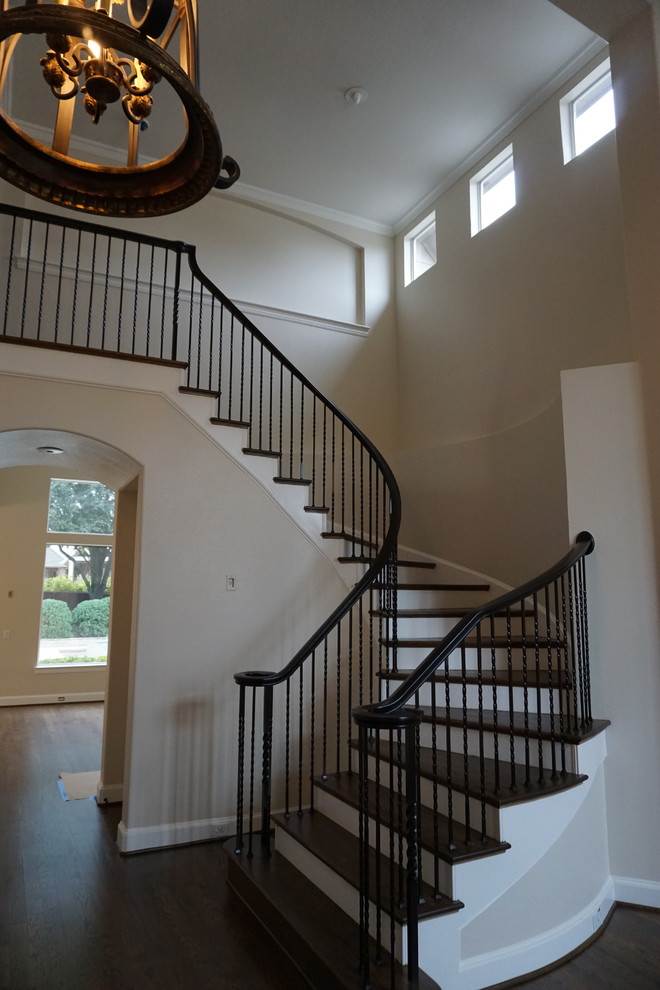 Inspiration for a mid-sized traditional wood u-shaped staircase in Dallas with painted wood risers.
