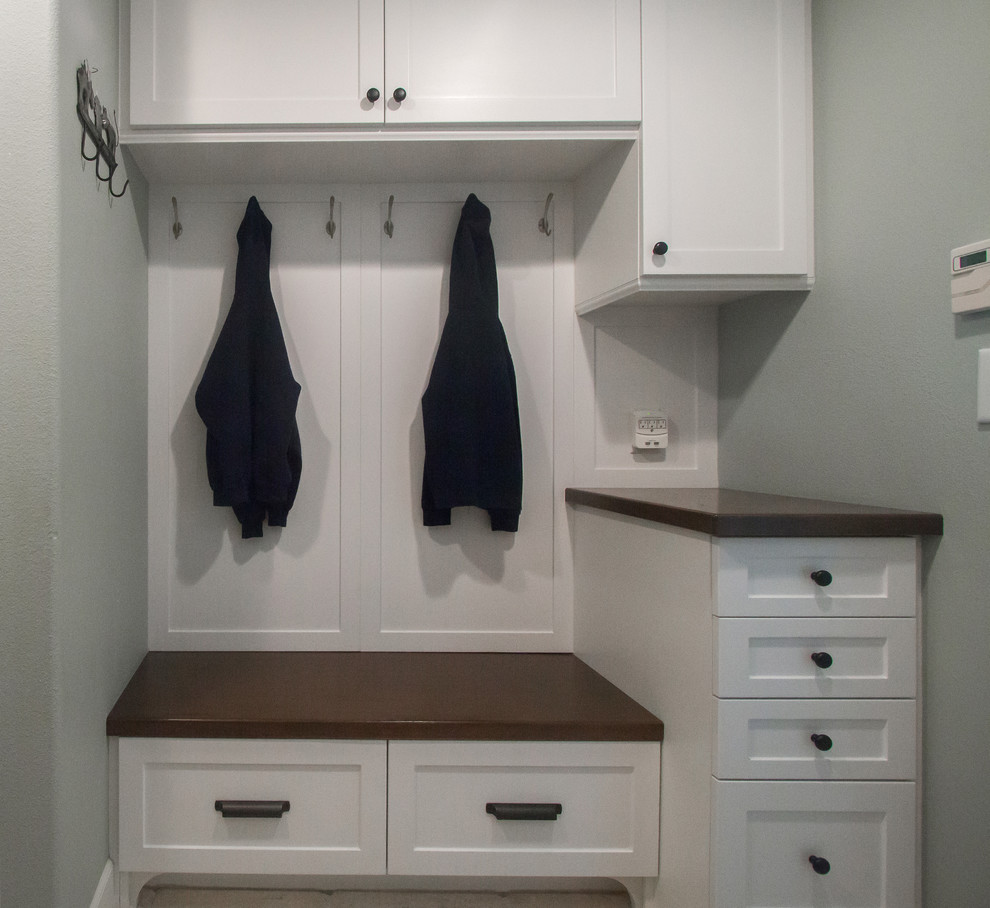 Inspiration for a mid-sized traditional galley utility room in Orange County with shaker cabinets, white cabinets, wood benchtops, grey walls and dark hardwood floors.