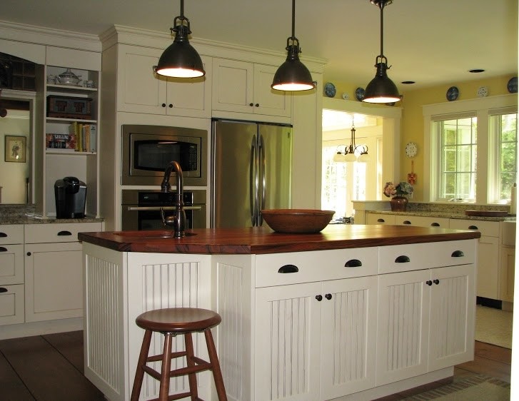 Design ideas for a mid-sized country u-shaped kitchen in Burlington with an undermount sink, shaker cabinets, white cabinets, granite benchtops, stainless steel appliances, dark hardwood floors and with island.