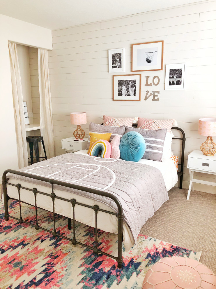 This is an example of a transitional kids' bedroom for girls in Seattle with white walls, carpet, beige floor and planked wall panelling.