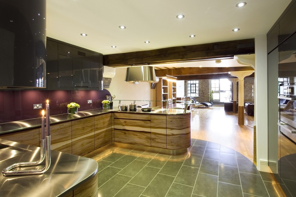 Inspiration for a mid-sized contemporary u-shaped open plan kitchen in London with an undermount sink, flat-panel cabinets, medium wood cabinets, stainless steel benchtops, pink splashback, glass sheet splashback, stainless steel appliances, ceramic floors and with island.