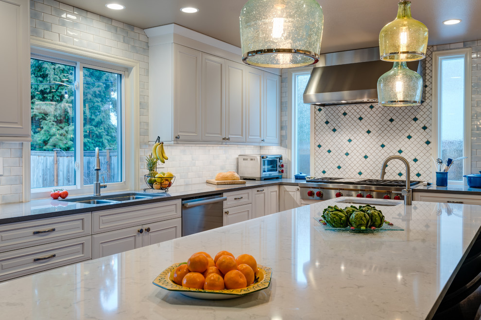 Large transitional u-shaped light wood floor eat-in kitchen photo in Seattle with an undermount sink, beaded inset cabinets, blue cabinets, quartz countertops, multicolored backsplash, porcelain backsplash, stainless steel appliances and an island