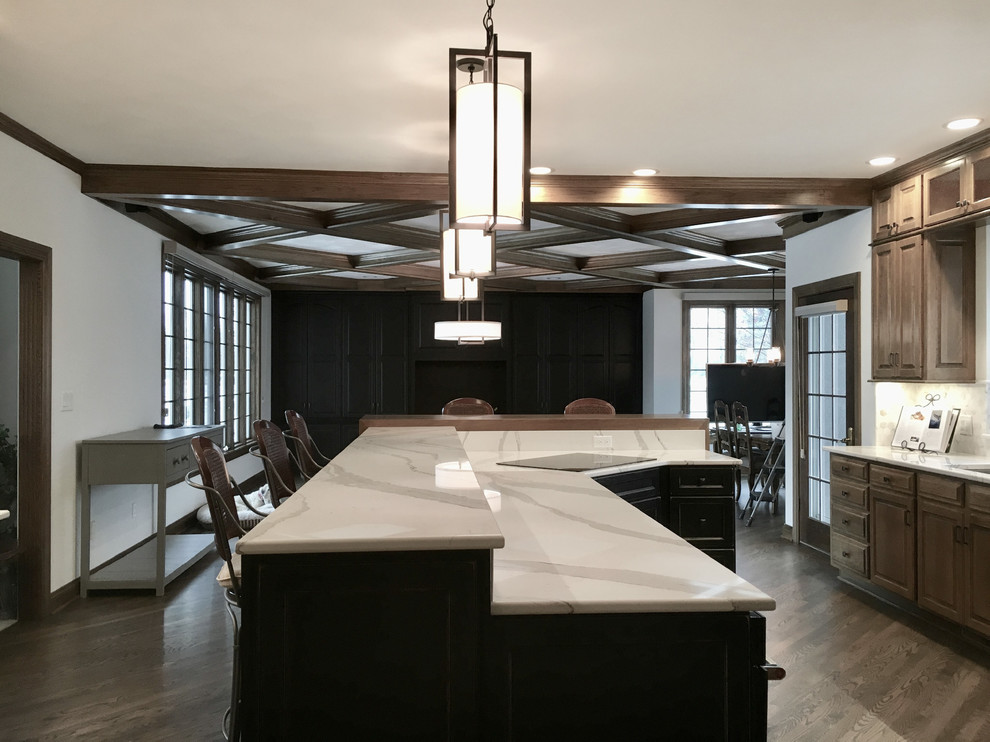 Inspiration for a large transitional u-shaped medium tone wood floor open concept kitchen remodel with an undermount sink, raised-panel cabinets, medium tone wood cabinets, quartz countertops, multicolored backsplash, mosaic tile backsplash, stainless steel appliances and an island