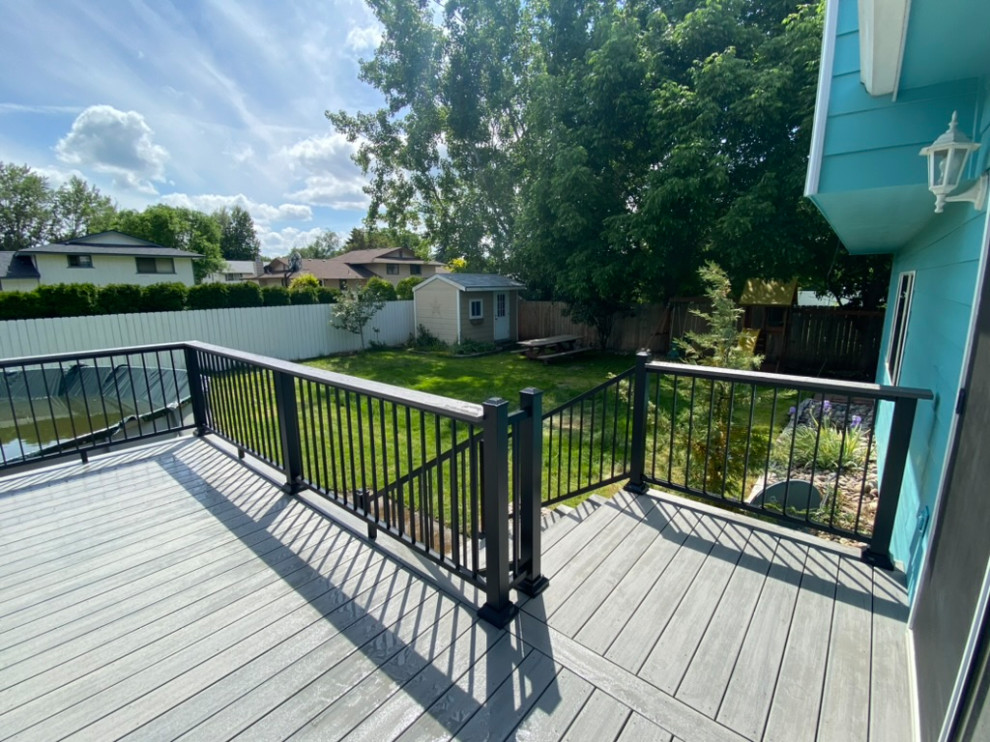 Example of a large backyard metal railing deck design in Seattle