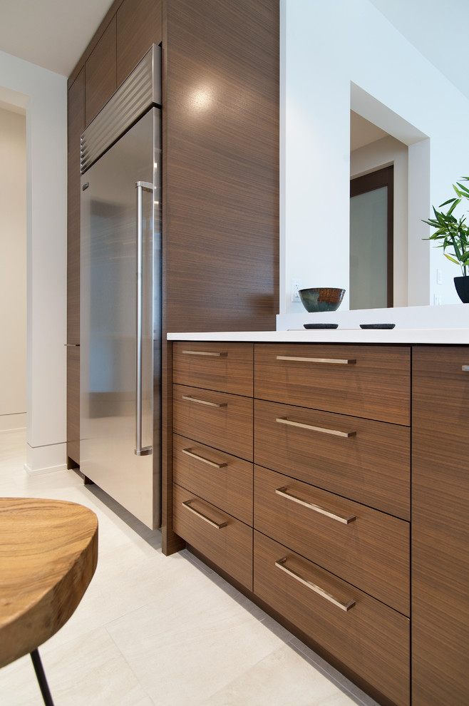 Photo of a contemporary u-shaped eat-in kitchen in Vancouver with an undermount sink, flat-panel cabinets and medium wood cabinets.